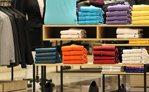 Clothing store with colorful shirts folded