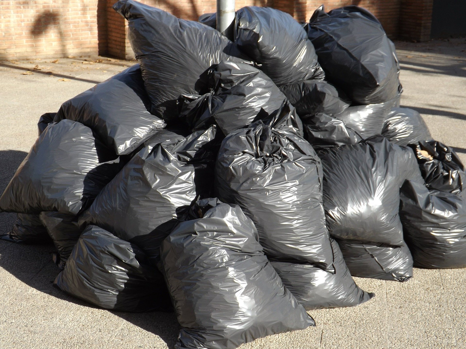 Black garbage bags filled and stacked in a pile