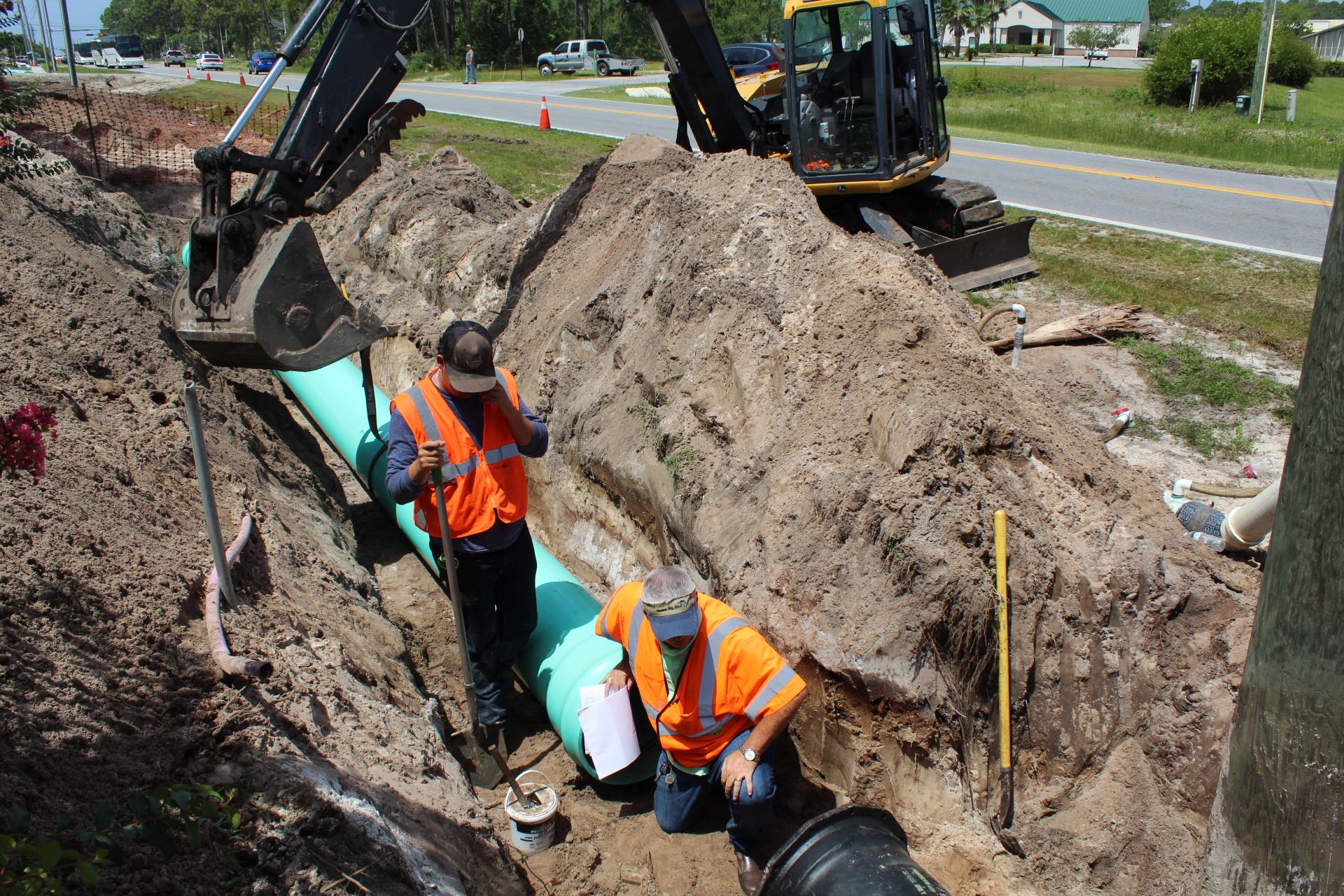 Utilities Field Inspector looks into newly installed sewer pipe